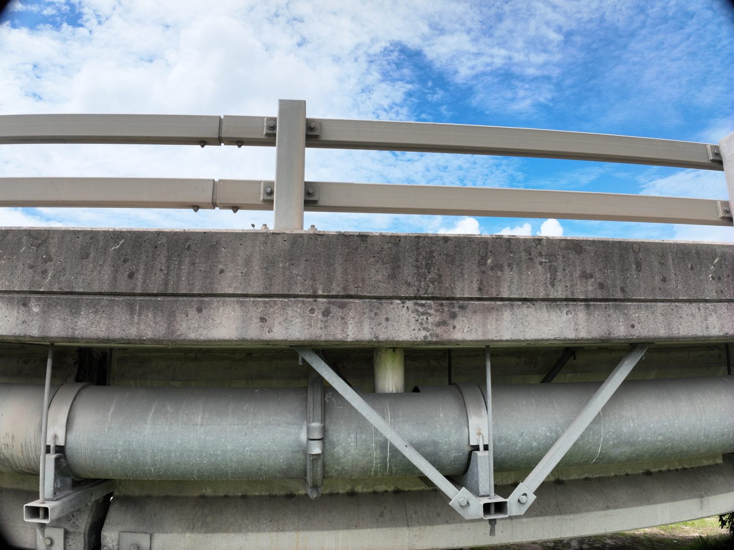 Close drone inspection detail beneath the M1 highway bridge over the Logan River
